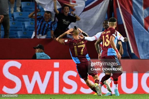 Trabzonspor's Slovak midfielder Marek Hamsik celebrates with Trabzonspor's Turkish defender Eren Elmali after scoring his team's first goal during...