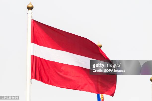 The flag of Latvia seen in the gallery of flags of the participating countries in the framework of St. Petersburg International Gas Forum 2022 .
