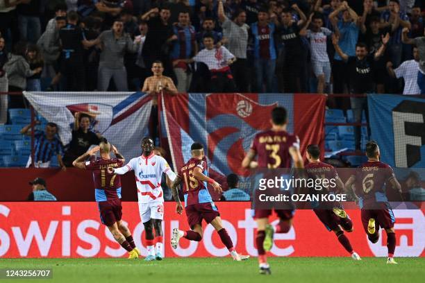 Trabzonspor's Slovak midfielder Marek Hamsik celebrates teammates after scoring his team's first goal during the UEFA Europa League group H football...
