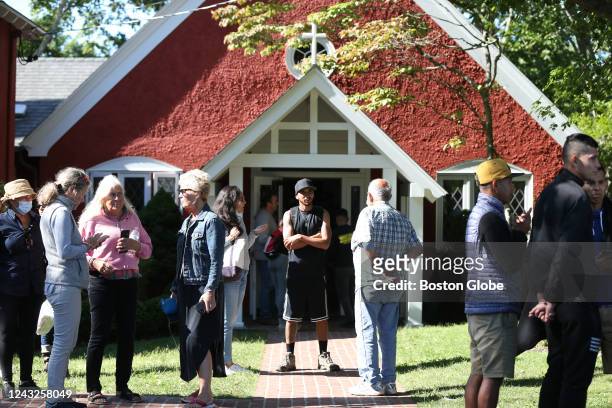 Martha's Vineyard, MA Volunteers mingle outside of St. Andrews Episcopal Church. Two planes of migrants from Venezuela arrived suddenly Wednesday...