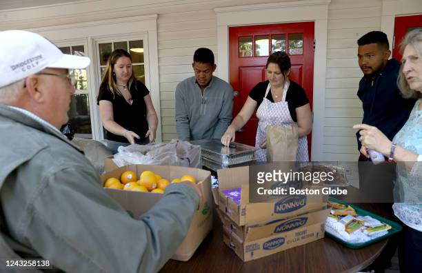 Martha's Vineyard, MA Volunteers help serve food to the recently arrived migrants. Two planes of migrants from Venezuela arrived suddenly Wednesday...