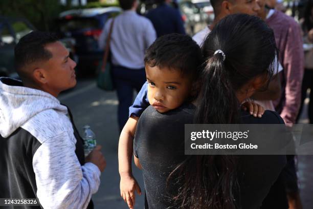 Martha's Vineyard, MA A mother and child spent some time outside the St. Andrew's Parrish House where migrants were being fed lunch with donated food...