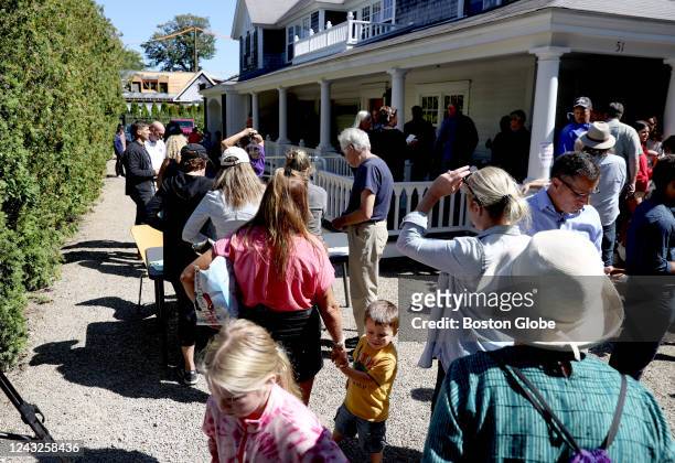 Martha's Vineyard, MA Marthas Vineyard residents line up in front of St. Andrews Parish House to donate food to the recently arrived migrants. Two...