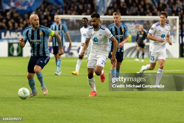 Magnus Eriksson of Djurgarden in a duel with Etzaz Muzafar Hussain of Molde during the UEFA Europa Conference League group F match between...