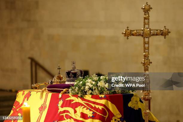 The coffin of Queen Elizabeth II, draped in the Royal Standard with the Imperial State Crown and the Sovereign's orb and sceptre, lying in state on...