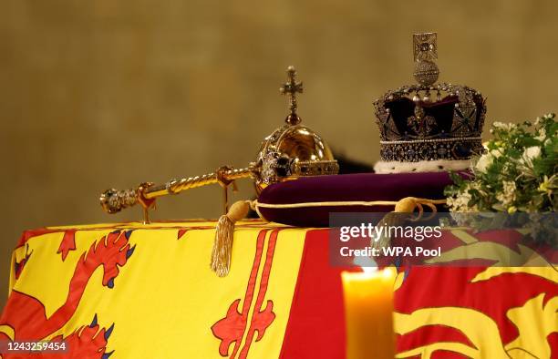 The coffin of Queen Elizabeth II, draped in the Royal Standard with the Imperial State Crown and the Sovereign's orb and sceptre, lying in state on...