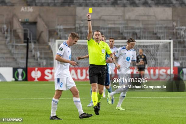 Referee Gergo Bogar shows a yellow card to Moldes Sivert Heggheim Mannsverk during the UEFA Europa Conference League group F match between...