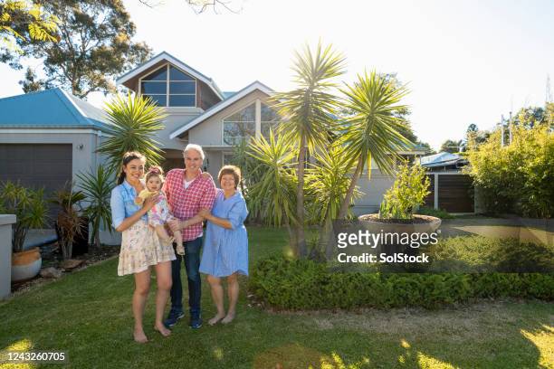 family portrait in front of their home - perth australia stock pictures, royalty-free photos & images