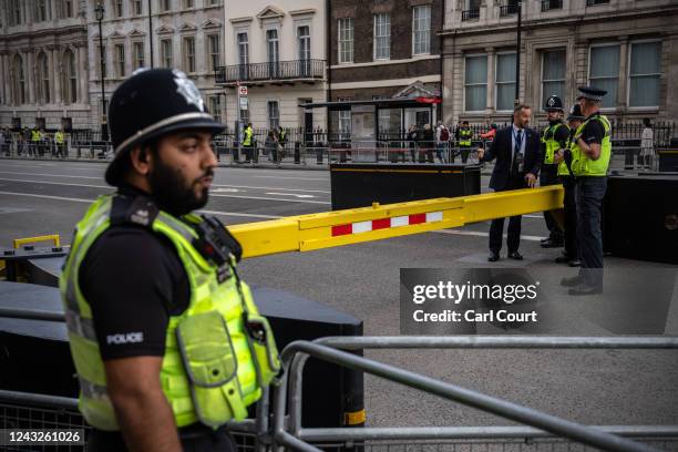 Police officers guard a road block near the Palace of Westminster ahead of the funeral of Queen Elizabeth II, on September 15, 2022 in London, United...