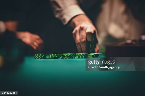 gentlemen holding gambling chips in casino - casino tokens checks or chips stock pictures, royalty-free photos & images