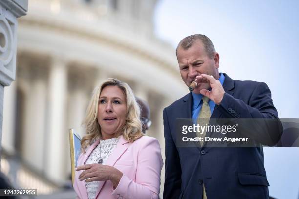 Reps. Marjorie Taylor Greene and Troy Nehls walk down the House steps after the last votes of the week at the Capitol September 15, 2022 in...