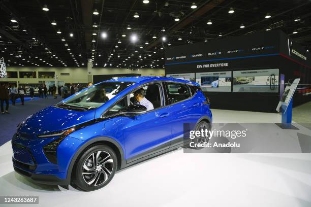 Visitor at the Detroit Auto Show speaks to a Chevrolette representative through the window of a 2022 Chevy Bolt EV, in Downtown Detroit, Michigan on...