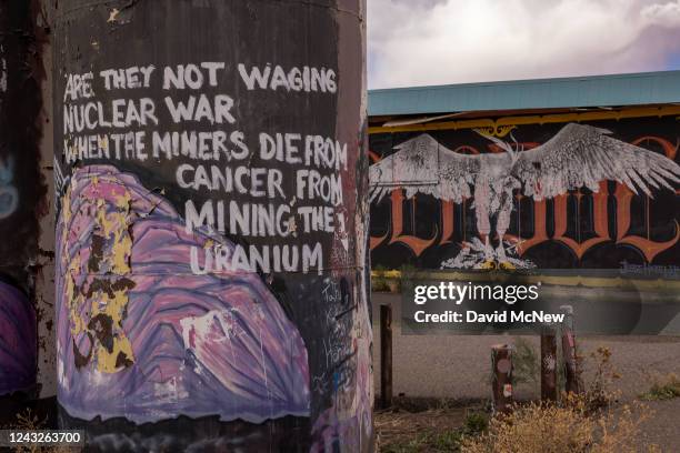 Message about uranium mine cancer deaths is seen painted on an abandoned tank on September 12, 2022 on the Navajo Nation near Cameron, Arizona....