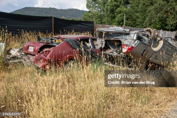 July 30, 2022- Abandoned cars, one turned upside down along the side of a road, emblematic of the decay in the town on Saturday, July 30, 2022 in...