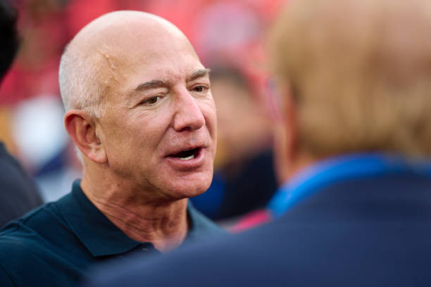 Jeff Bezos looks on from the sidlines before kickoff between the Kansas City Chiefs and Los Angeles Chargers at GEHA Field at Arrowhead Stadium on...