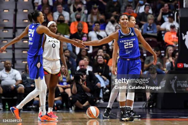 Alyssa Thomas of the Connecticut Sun high fives DeWanna Bonner of the Connecticut Sun during Game 3 of the 2022 WNBA Finals against the Las Vegas...