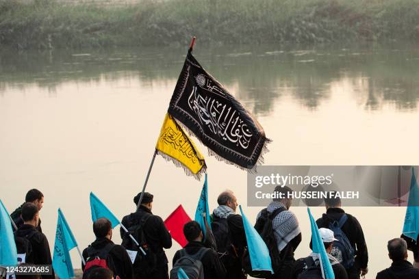 Shiite Muslim pilgrims march towards Iraq's holy city of Karbala to attend the Arbaeen religious commemoration, on September 13, 2022 near the city...