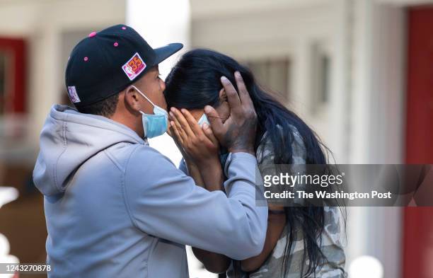 Edgartown MA - September 15th 2022: Rafael Eduardo an undocumented immigrant from Venezuela hugs another immigrant outside of the Saint Andrews...