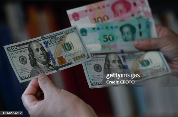 16 Rmb FUYANG, CHINA - SEPTEMBER 16, 2022 - Chinese RMB and US dollars are ...