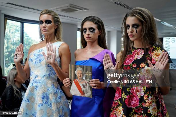 Models pose with a Tribute to the late Queen Elizabeth II before presenting creations from the SOHUMAN Spring/Summer 2023 catwalk show on the second...