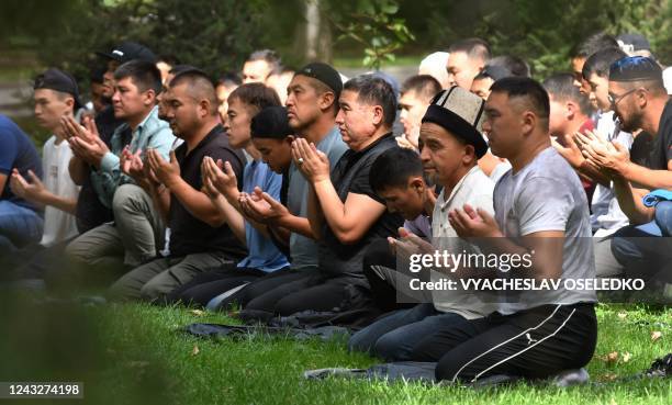 Protesters pray during a rally to demand of the authorities to support residents of Kyrgyzstan's southern Batken province following border clashes...