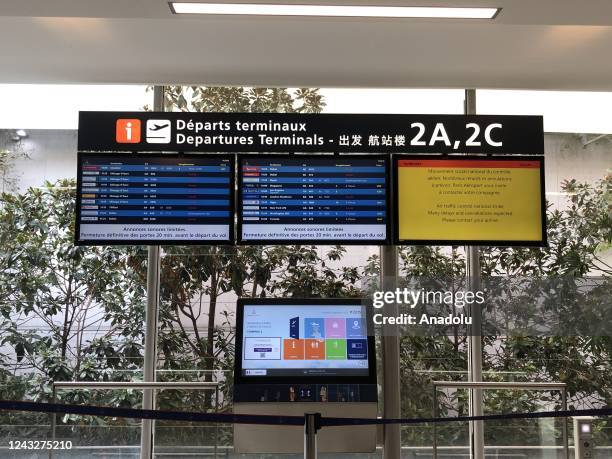 Screen displaying cancelled and delayed fliights at Paris Charles De Gaulle International Airport as air traffic controllers go on a strike with the...