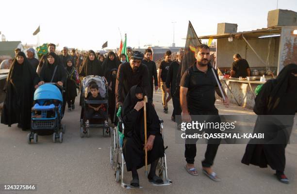 Shiite Muslim pilgrims march towards Iraq's holy city of Karbala to attend the Arbaeen religious commemoration on September 16 in the central city of...