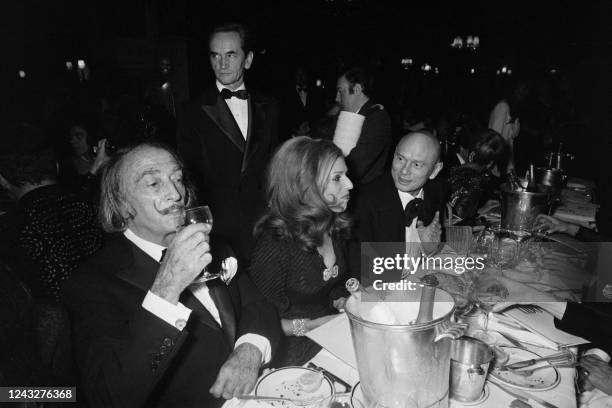 Spanish painter Salvador Dali and Russian-American actor Yul Brynner dine at the Lido during the gala night of the famous Parisian cabaret, on...