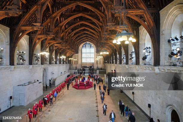 Chelsea Pensioners join members of the public as they pay their respects as they pass the coffin of Queen Elizabeth II as it Lies in State inside...