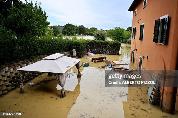 Photograph shows a flooded courtyard following an overnight rain bomb in Sassoferrato, Ancona province, on September 16, 2022. - At least ten people...