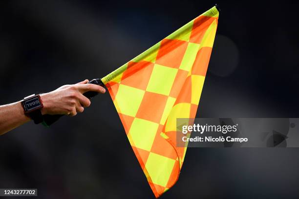 Flag raised by the linesman to signal an offside as a clock displays the word 'goal' is seen during the UEFA Champions League football match between...