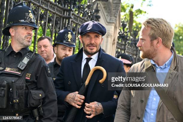 English former football player David Beckham leaves Westminster Hall, at the Palace of Westminster, in London on September 16, 2022 after paying his...