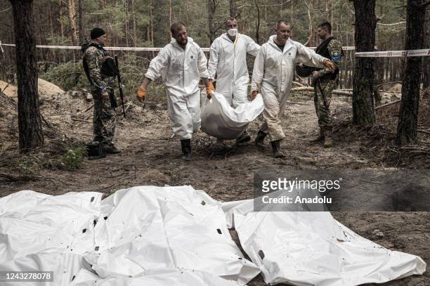 Ukrainian authorities exhume bodies of people killed as a result of war at the Izium city after Russian Forces withdrawal in, Kharkiv Oblast, Ukraine...