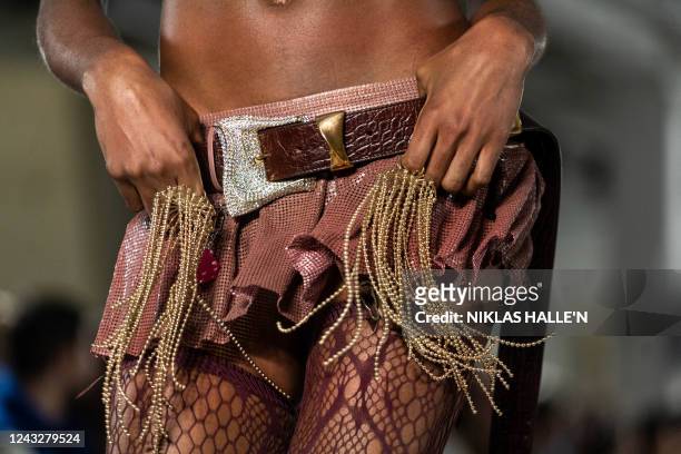 Models present creations by British designer Poster Girl during a catwalk show on the second day of London Fashion Week June Edition in London on...