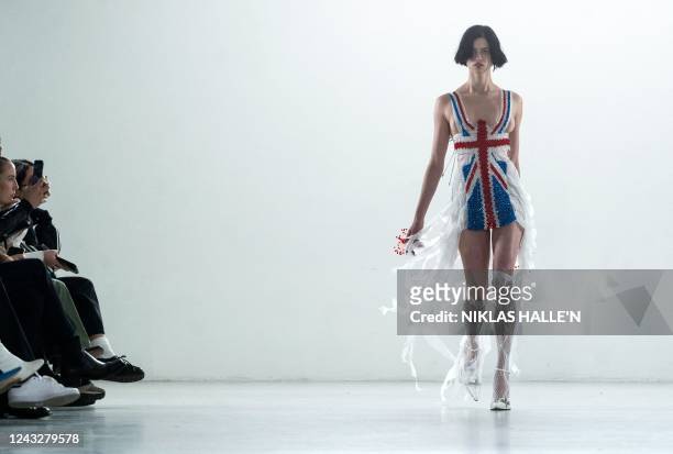 Models present creations by British designer Poster Girl during a catwalk show on the second day of London Fashion Week June Edition in London on...