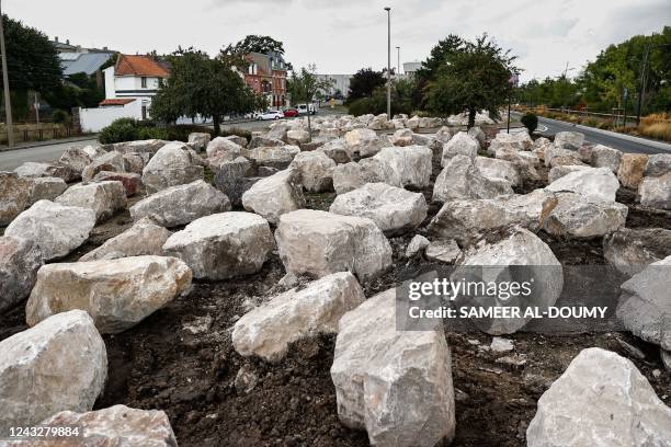 This photograph taken on September 16 shows rocks installed by Calais' town hall to prevent migrants from settling in the city centre of Calais. -...