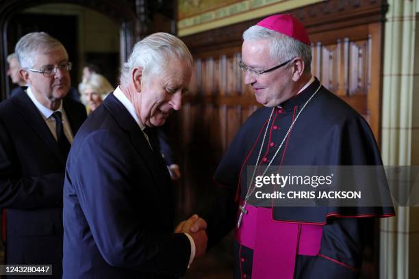 Britain's King Charles III meets with Archbishop of Cardiff Mark O'Toole at a reception for local charities at Cardiff Castle, in Cardiff, in south...