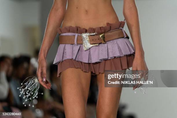 Models present creations by British designer Poster Girl during a catwalk show on the second day of London Fashion Week June Edition in London on...