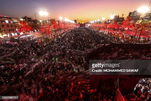 This long-exposure picture taken on September 16, 2022 shows Shiite Muslim devotees gathering in Iraq's central holy shrine city of Karbala between...