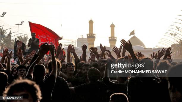 Shiite Muslim devotees gather in Iraq's central holy shrine city of Karbala on September 16, 2022 between the Imam Abu Al-Fadl Al-Abbas shrine and...