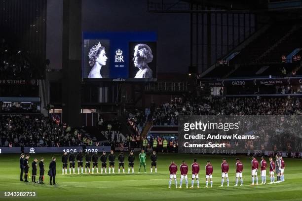 Players and officials pay their respects to the late Queen Elizabeth II during the Premier League match between Aston Villa and Southampton FC at...