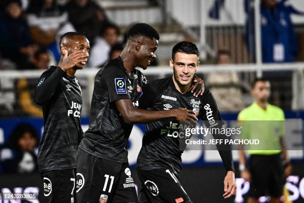Lorients Burkinabe forward Dango Ouattara celebrates with his teammates after scoring a goal during the French L1 football match between AJ Auxerre...