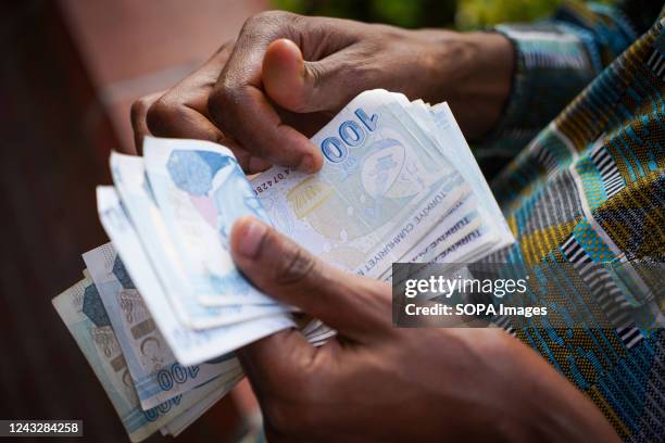 Man counts 100 Turkish lira banknotes in Ankara City.