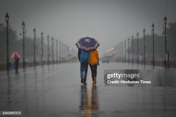 Visitors with umbrella seen at Kartavya Path on a rainy day on September 16, 2022 in New Delhi, India. A sustained spell of light rain in the capital...