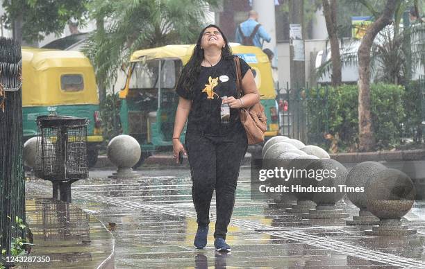 Grl enjoys rains at CP on September 16, 2022 in New Delhi, India. A sustained spell of light rain in the capital yielded the first "good" air quality...