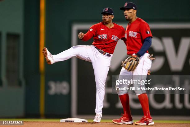 Rafael Devers and Xander Bogaerts of the Boston Red Sox turn a double play during the sixth inning of a game against the Kansas City Royals on...