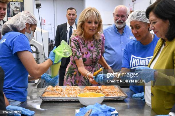 First Lady Jill Biden next to Homeboy Industries founder Father Gregory Boyle, helps make pastries during a visit to the Homeboy Bakery and Homegirl...