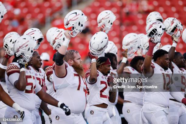 Florida State Seminoles players get ready before an NCAA football game against the Louisville Cardinals on September 16, 2022 at Cardinals Stadium in...