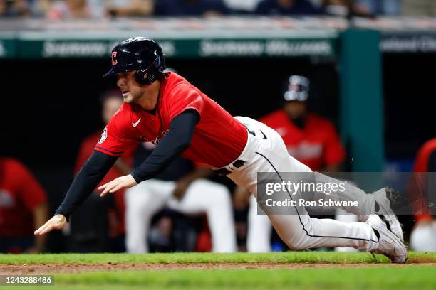 Ernie Clement of the Cleveland Guardians scores on a wild pitch by Jhoan Duran of the Minnesota Twins during the eighth inning at Progressive Field...