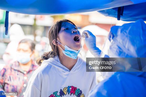 Citizens take nucleic acid tests at a nucleic acid screening point in a residential community in Bijie, Guizhou province, Sept 16, 2022.